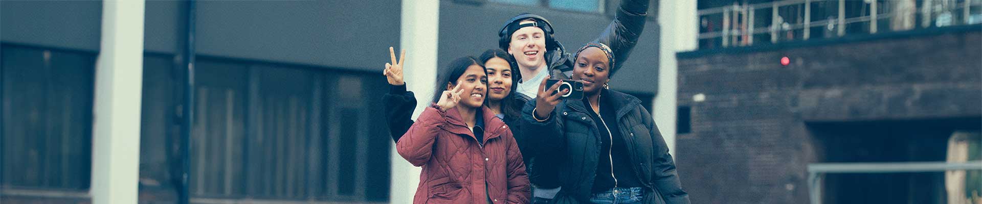 Group of students stood together in the Coventry Cathedral ruins