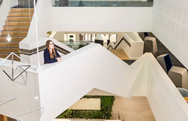 Female student stood on staircase.