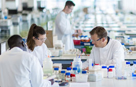 Medical students in a lab looking through microscopes