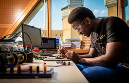 Black male using a soldering iron