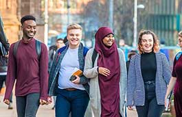 Young students walking in front of Coventry Cathedral.