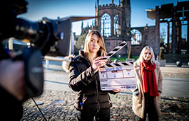 Students filming in the Coventry Cathedral ruins