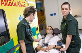 Female nurses getting a patient out of an ambulance