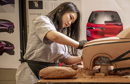 A student working on a vehicle model