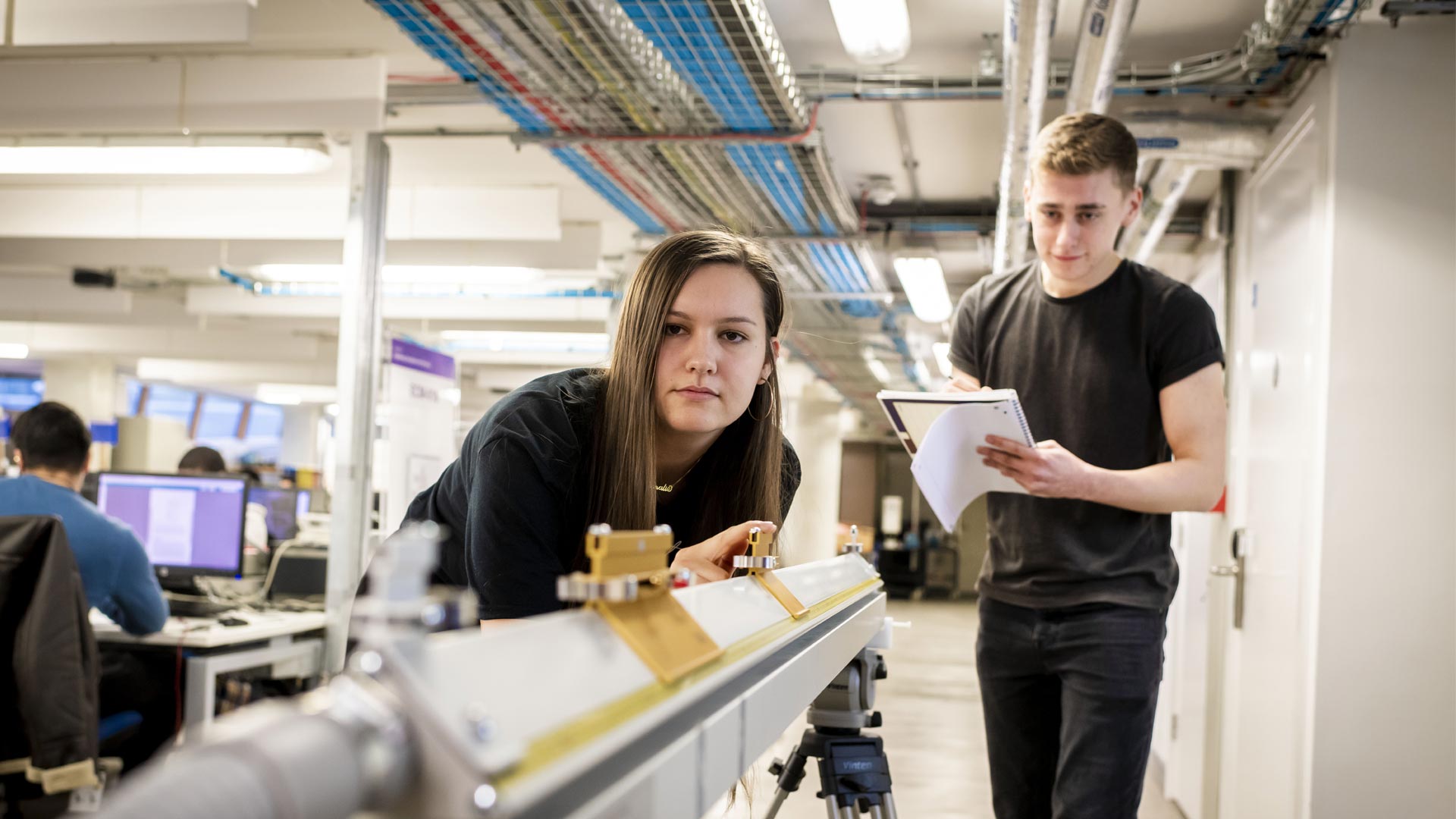 Two students using equipment in the lab.