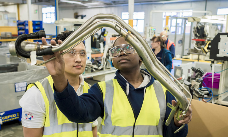 Two students in the manufacturing workshop