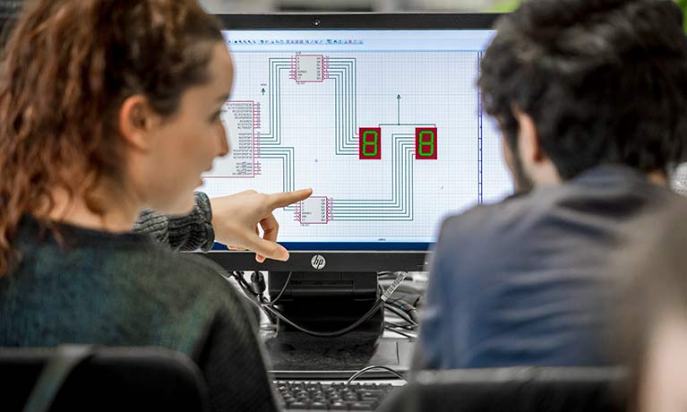 Two learners looking at a computer screen