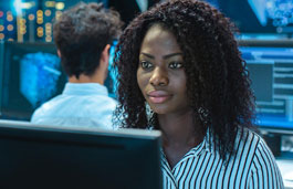 Students working on desktops in computer suite