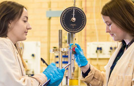 Two female students working in a lab