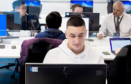 Man working on a computer that displays random code