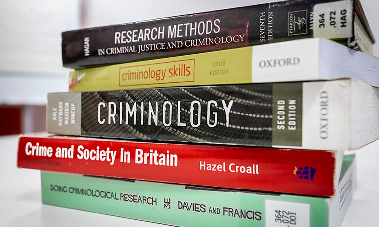 stack of criminology books 