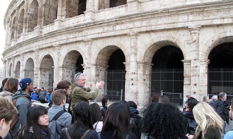 Richard with a group of students in front of an ancient building