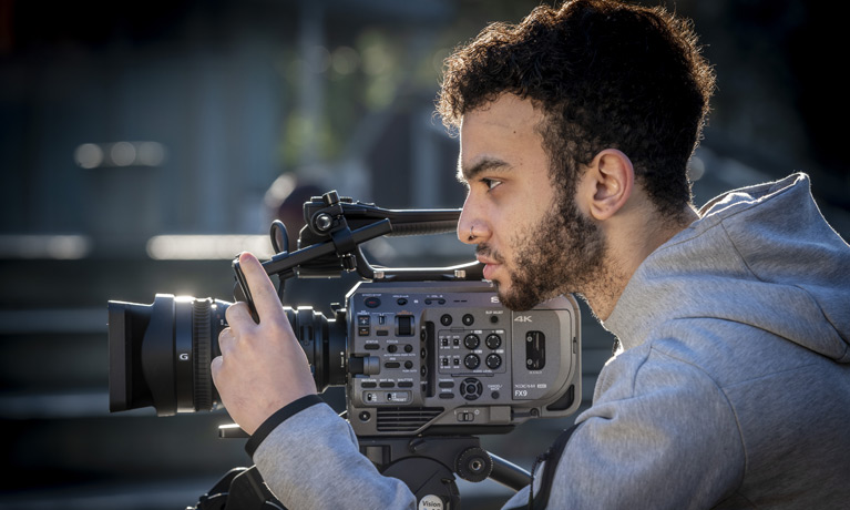 A student filming outside in Coventry