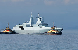 Large military surveillance ship with two smaller boats before and after it