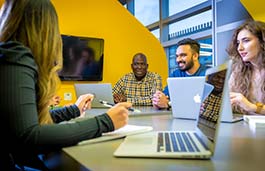 Four students in discussion across a table