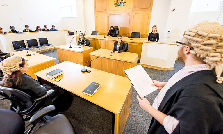 Students practicing legal skills in a mock courtroom