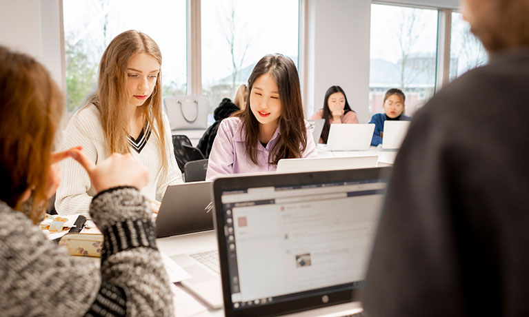 Two women looking at a laptop