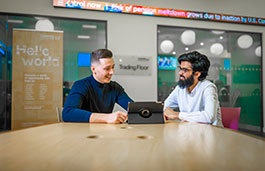 Students in a meeting room in conversation. 