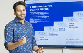 Student presenting a slide show in a boardroom