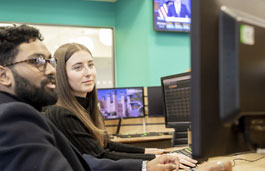 Two students using the Bloomberg terminals on the Trading Floor
