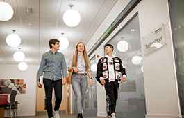 3 students walking in a corridor in Business Law buildling