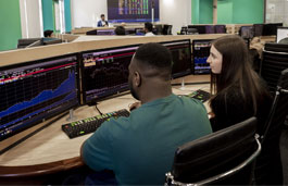 Students working on a Bloomberg terminal on the Trading Floor