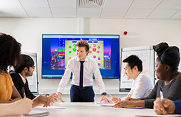 Three male students and two female students in a meeting with a presentation on screen