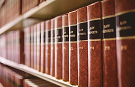 Multiple law report books on a bookshelf