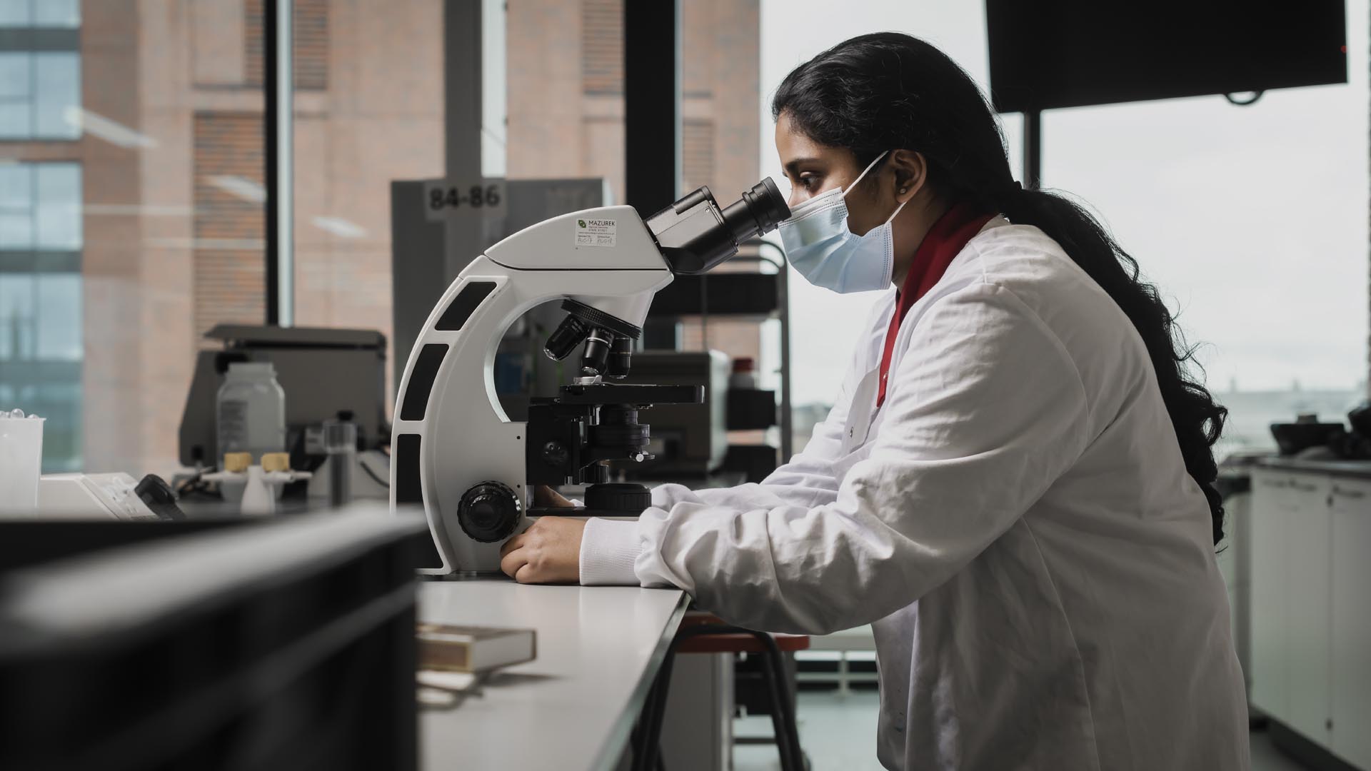 Student looking through a microscope