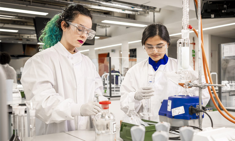 2 laboratory assistants working in a lab  