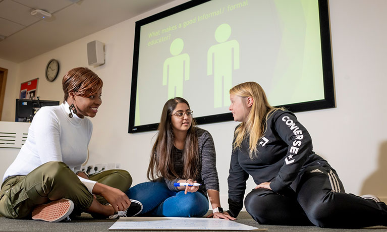 Students talking in a classroom