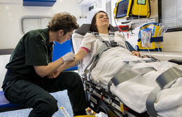 Student working on a patient in the mock ambulance