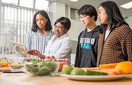 lecturer showing students a food chart