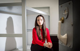 Student sat in a mock prison cell on campus
