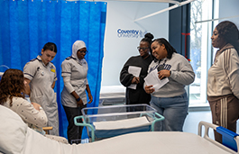 Students in a ward helping a patient