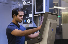 student using engineering lab machinery