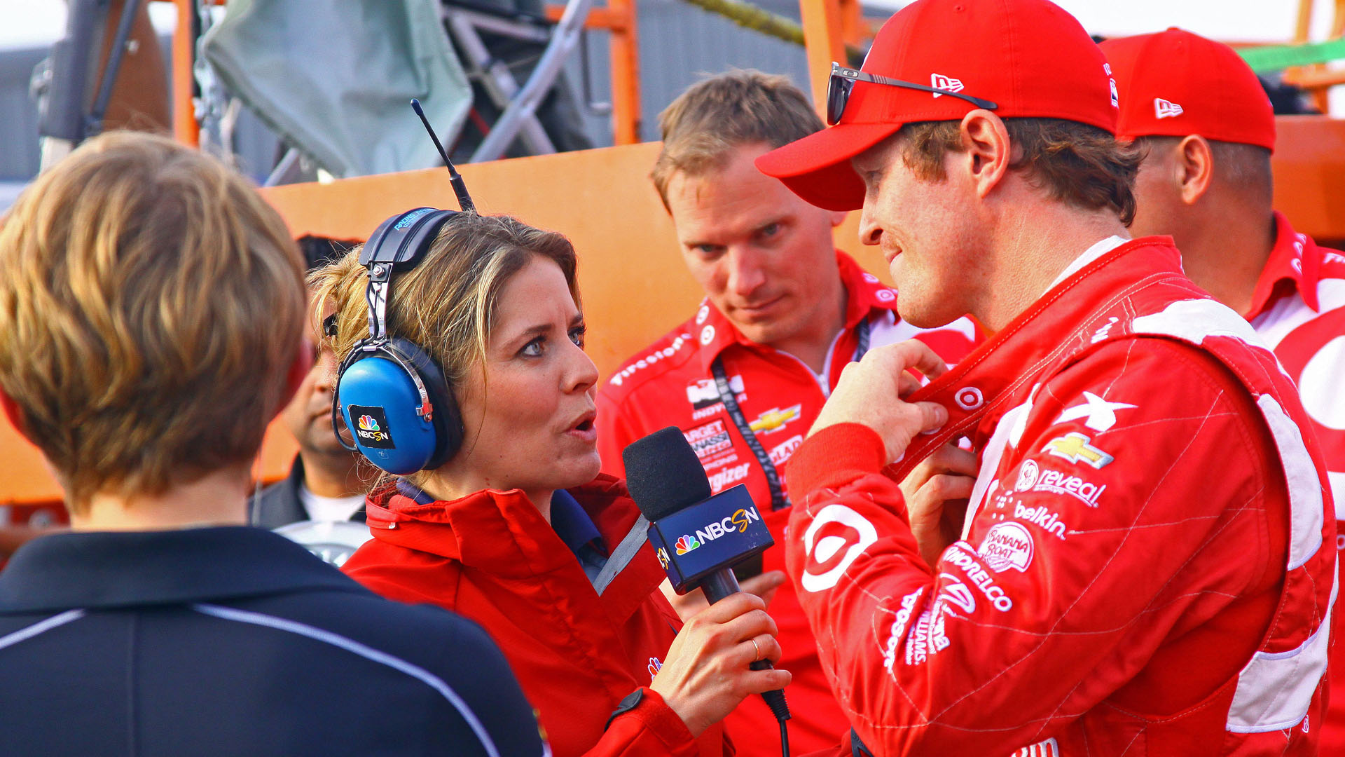 Female reporter interviewing a male race driver 