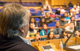 Lecturer facing students in a lecture theatre 