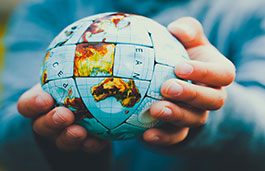 Close up image of a person holding a globe 