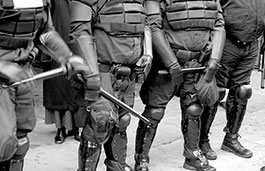 Black and white photo of police in riot gear
