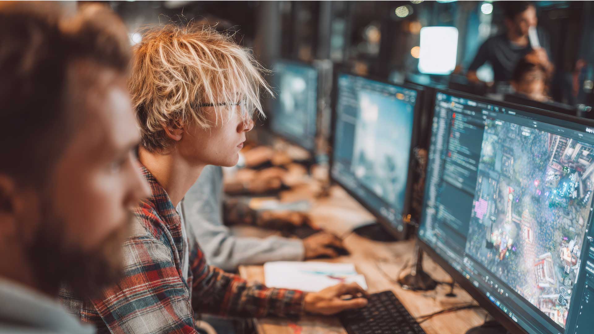 programmers sitting in a row focusing on screens