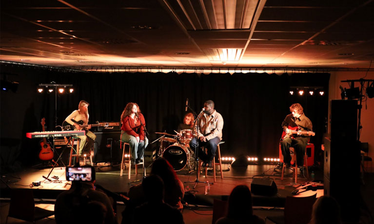 a band playing on a dimly lit stage