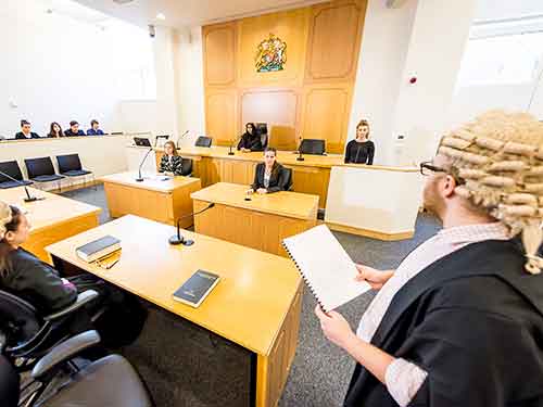 Students practicing legal skills in moot room Students practicing legal skills in moot room