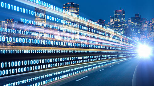 Graphic image of city skyline at night with an array of the numbers 1 and 0 in lines
