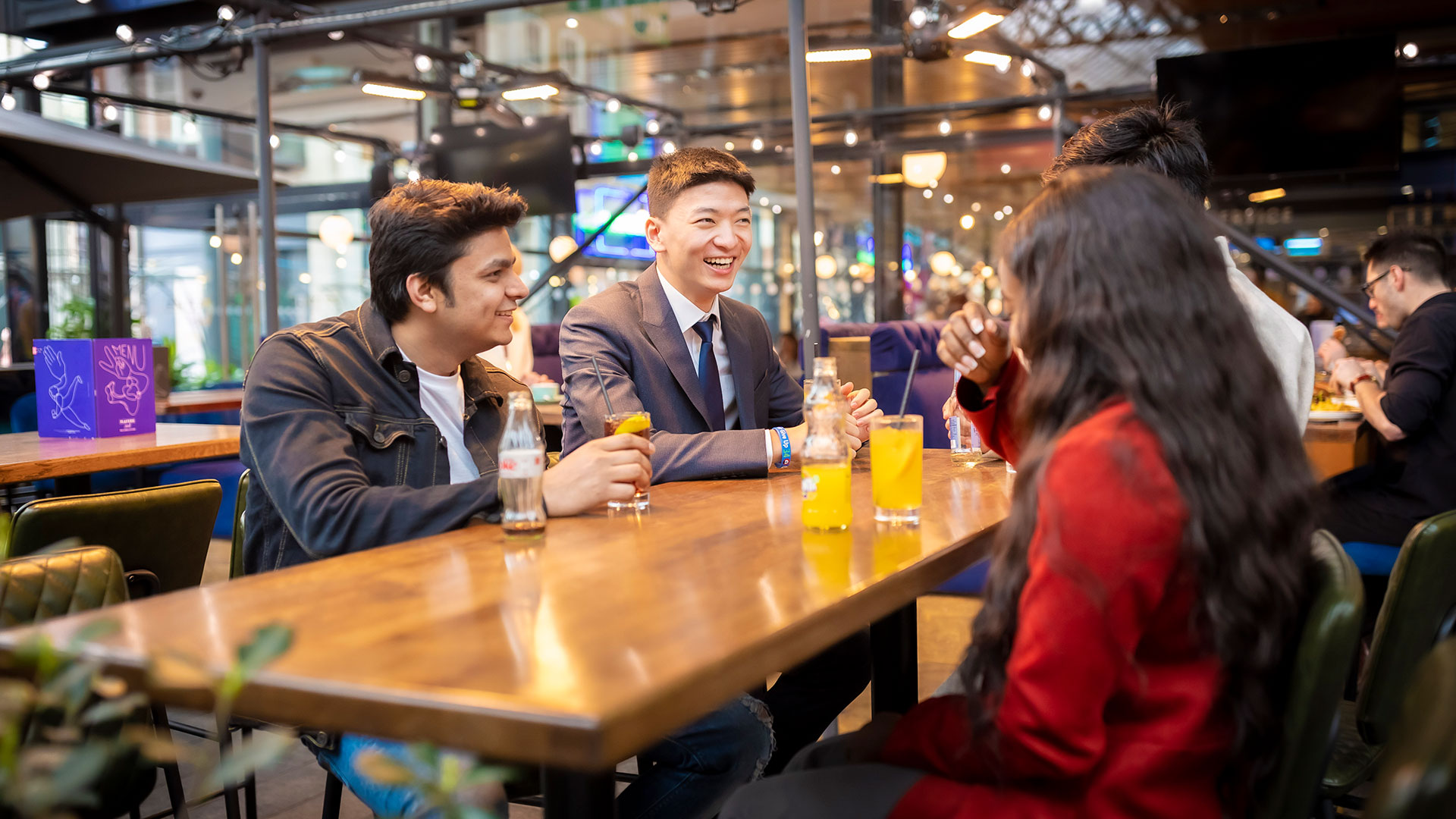 Two people laughing in an outdoor bar area