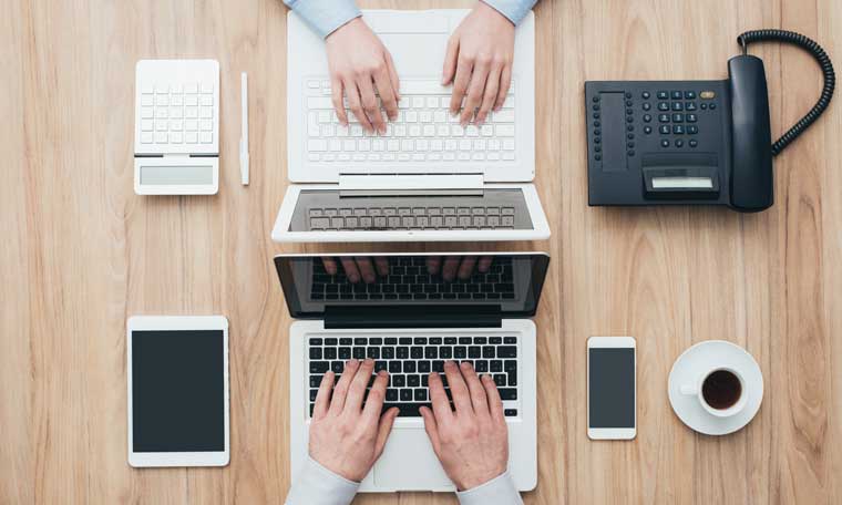 Two people working on devices
