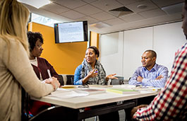 Group of people having a conversation at a table