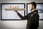 Male student looking at model of property