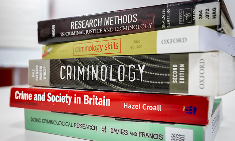 A stack of books about Criminology