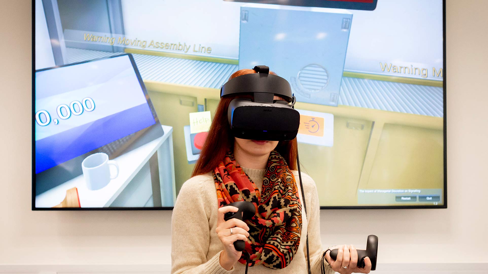 woman wearing a VR headset and holding remote controls